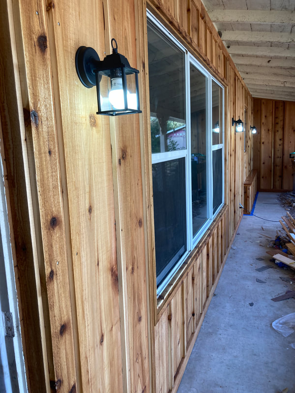 New cedar board and batten front porch wall with new window and lights, BILLS BARN LA GRANGE, LA GRANGE, FAYETTE COUNTY, TEXAS, 78945, 78954, Texas Ranch Specialist, Round Top Barn Repair, Handyman near me, Handyman near me small jobs, Cheap handyman near me, Licensed and bonded handyman near me, Independent handyman services, craigslist handyman, handywoman, Handyperson, handyman hardware, woodworker, carpenter, general contractor, custom home builder, construction company, one of a kind